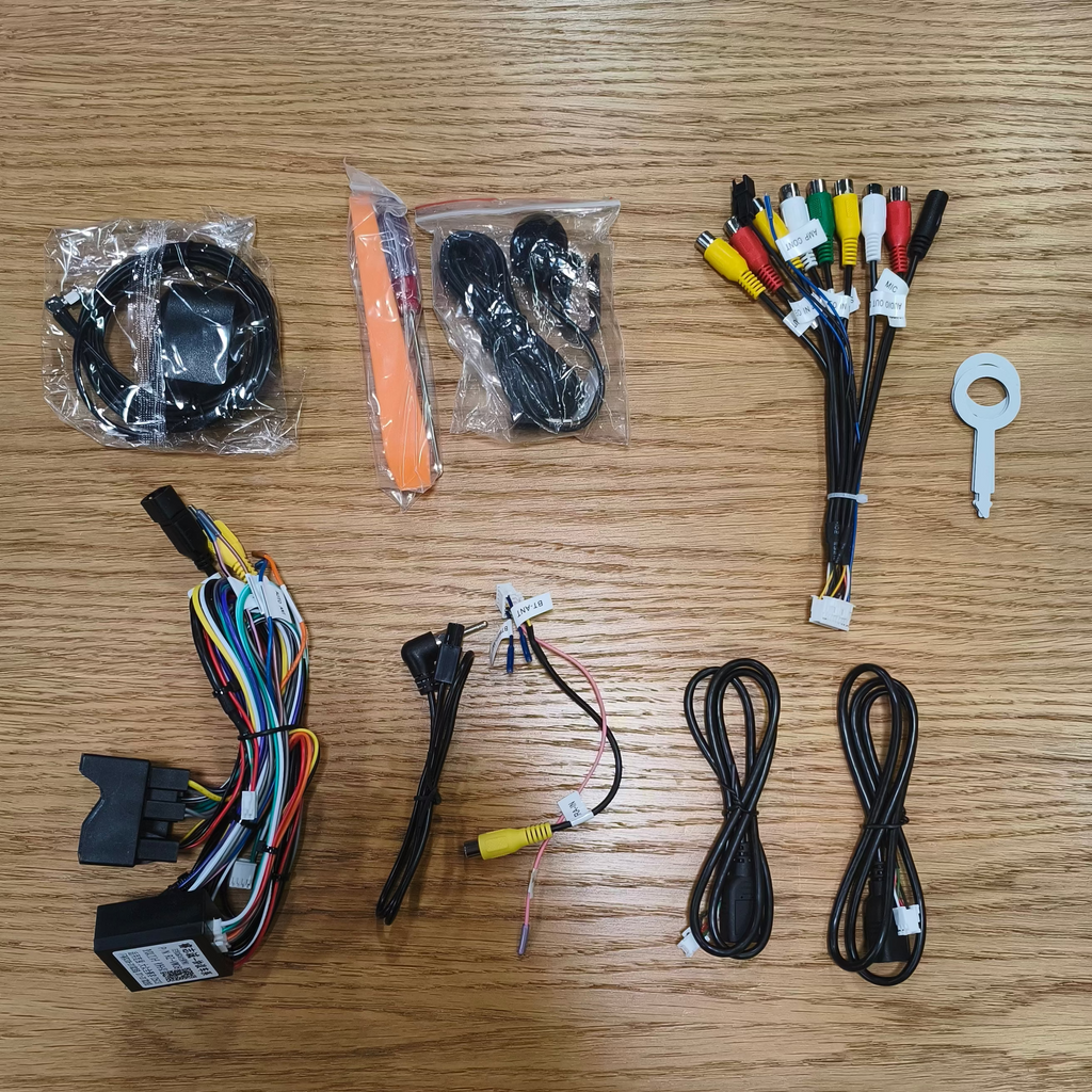 Collection of electronic wiring harnesses and connectors on a wooden surface