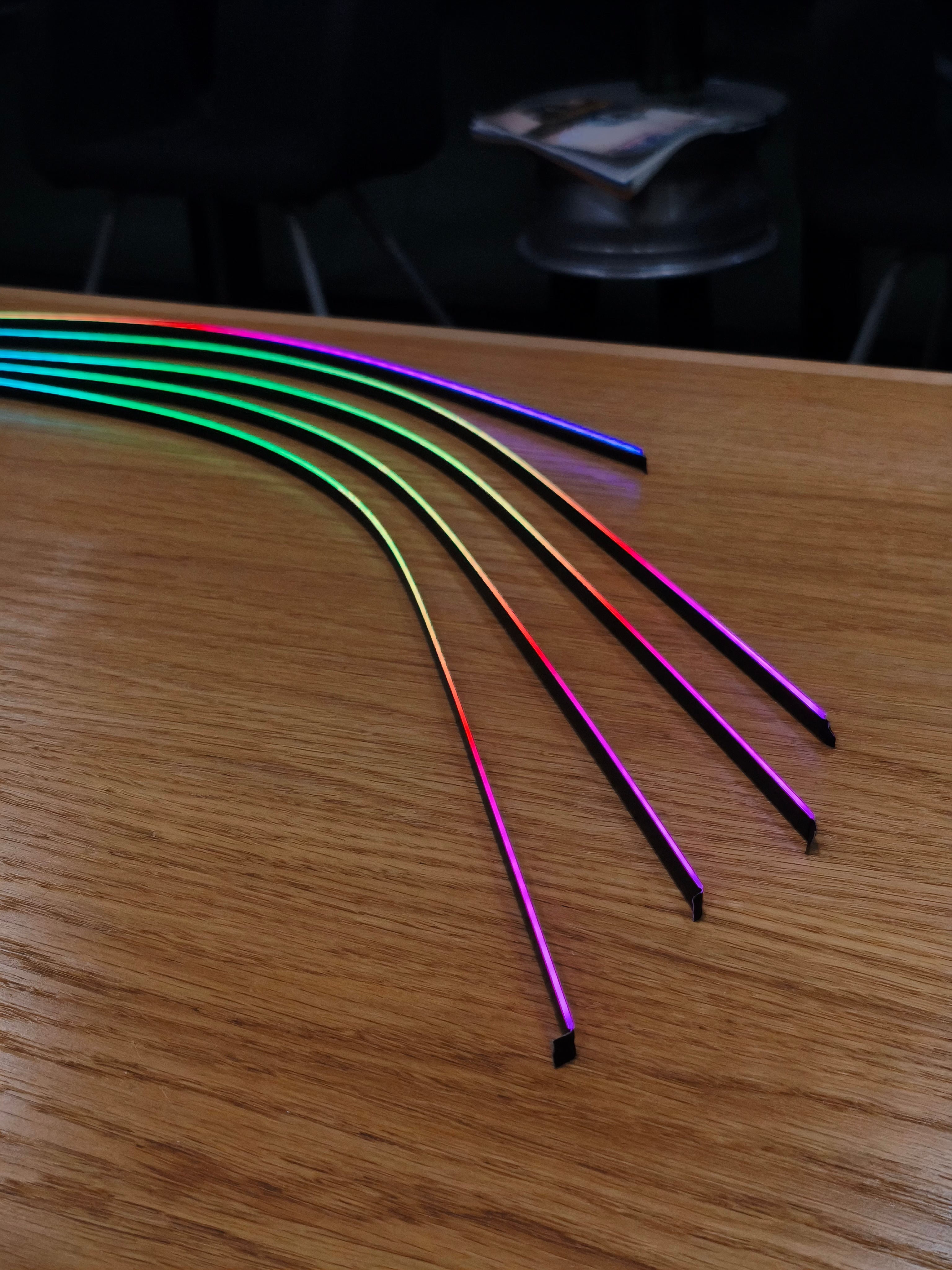 Colorful LED strip lights on a wooden surface
