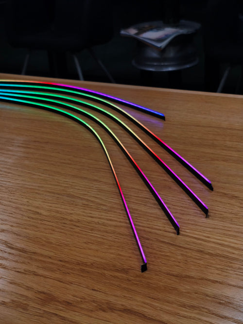 Colorful LED strip lights on a wooden surface